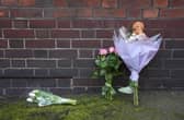Flowers and a toy animal left near the Peabody Estate building in Horseferry Road in central London, after a baby girl fell from height. 