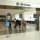Travellers enter a Transportation Security Administration (TSA) checkpoint at Los Angeles International Airport (LAX) in Los Angeles, California on March 23, 2026. Immigration and Customs Enforcement (ICE) agents will be deployed in US airports beginning March 23, aiming to alleviate soaring congestion at security screenings amid a weeks-long budget standoff over President Donald Trump's mass deportation drive, officials said. (Photo by Patrick T. Fallon / AFP via Getty Images)