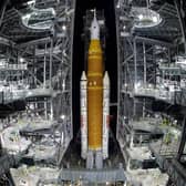 The NASA Artemis II rocket with the Orion spacecraft aboard leaves the Vehicle Assembly Building moving slowly to pad 39B at the Kennedy Space Center in Cape Canaveral