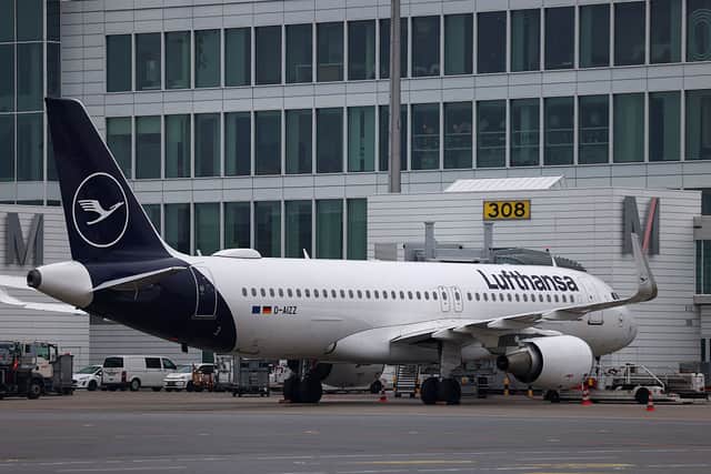 A plane of German airline Lufthansa sits on the tarmac on April 13, 2026 at Munich's international airport, as hundreds of Lufthansa flights were cancelled in Germany as pilots kicked off a strike over pay and pensions, the latest walkout at the German aviation giant this year. Half of all long-distance flights and two-thirds of short-haul services were cancelled at Lufthansa, the group's main airline, on the first day of the two-day industrial action, the company said. Pilots at its CityLine and Eurowings subsidiaries are also participating in the walkout. (Photo by Alexandra BEIER / AFP via Getty Images)