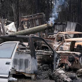 A utility pole burns in a vehicle lot scarred by the Brantley Highway 82 Fire on April 23, 2026 in Atkinson, Georgia. The wildfire is one of many burning in the southeastern United States. (Photo by Sean Rayford/Getty Images)