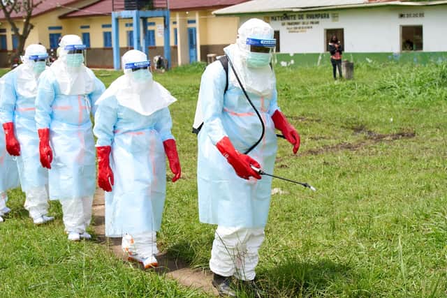Health workers arrive at an Ebola treatment centre for disinfection exercises in Rwampara, Congo