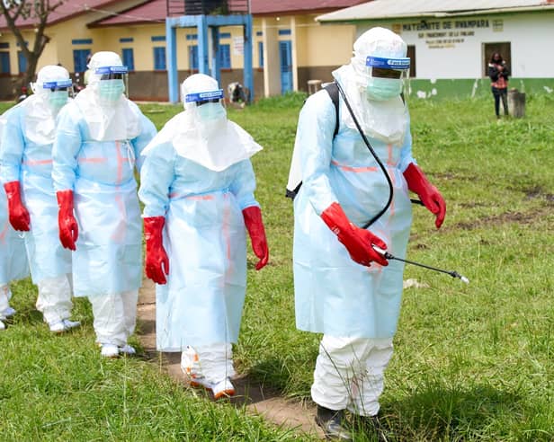 Health workers arrive at an Ebola treatment centre for disinfection exercises in Rwampara, Congo