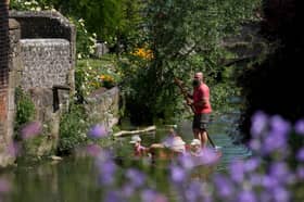 People enjoy punting through Westgate Gardens in Canterbury, Kent, as the warm weather continued today
