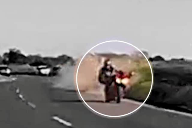 The shocking moment a motorcyclist was thrown from his bike into the road - narrowly avoiding oncoming traffic