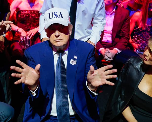 President Donald Trump gestures next to first lady Melania Trump during UFC Freedom 250 on the South Lawn of the White House