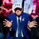 President Donald Trump gestures next to first lady Melania Trump during UFC Freedom 250 on the South Lawn of the White House