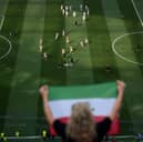 Fans cheer as Iran players warm up before the World Cup Group G football match between Iran and New Zealand