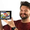 An empty box which originally contained the 1996 Nintendo 64 game Super Mario 64, signed by Mario creator and ‘father of modern gaming’ Shigeru Miyamoto, has sold for £8,450. It was part of multiple collections of trading cards and retro video games sold by Ewbank’s Auctioneers. Pictured is Ewbank’s specialist James Spooner holding the box.