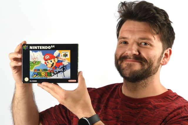 An empty box which originally contained the 1996 Nintendo 64 game Super Mario 64, signed by Mario creator and ‘father of modern gaming’ Shigeru Miyamoto, has sold for £8,450. It was part of multiple collections of trading cards and retro video games sold by Ewbank’s Auctioneers. Pictured is Ewbank’s specialist James Spooner holding the box.