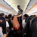 EasyJet passengers were stunned to see a man wearing a gimp suite collecting rubbish
