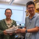 Simiao Niu, an assistant professor of biomedical engineering in the Rutgers School of Engineering (right), and doctoral student Fuying Dong work in the lab on a smart shoe powered by the wearer's footsteps