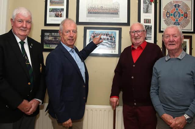 Pointing to a photograph of their late friend and colleague, Ernie Cockburn, are, from left, Cyril Monteith, David Donnell, Malachy Fegan and Kenny Smyth, who all served with him in the North Irish Militia. The photograph was taken at the Royal British Legion in Omagh. IB0143CD26