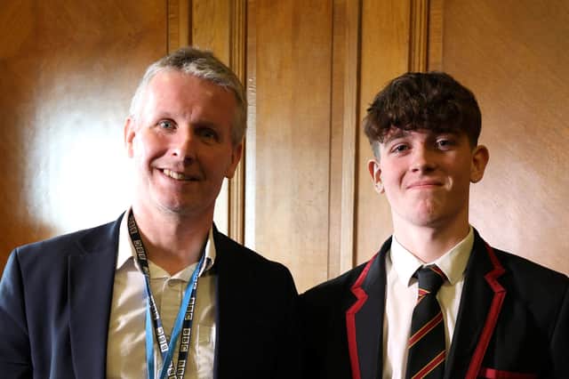Integrated College Dungannon Year 13 pupil, Marcas, is pictured with BBC News education and arts correspondent, Robbie Meredith.