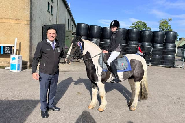 Omagh High School principal, Christos Gaitatzis, with Omagh High School pupil, Olivia Kerrigan on Duplo. SU1044CD26