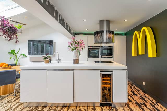 A giant illuminated McDonald's sign hangs on the kitchen wall, creating an unusual feature for prospective buyers.