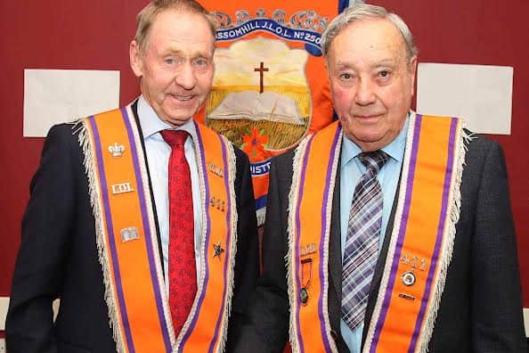 WM of Blossomhill LOL 411, Brian Beattie, left, and honorary member, Gary Hamilton, who cut the special cake to mark the 100th anniversary. IB3544CD26