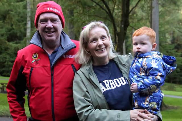 Raymond and Valerie McKinley with their grandson, Finn McKinley at the Gillygooley Youth and Community Development Association's Gortin Glen Sponsored Walk. IB0742CD26