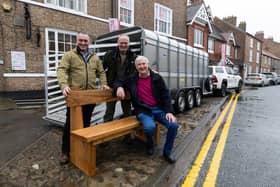 Farming brothers, from left, Dave and Rob Nicholson, with TV vet Peter Wright, outside the World of James Herriot museum in Thirsk with the memorial bench and the Ifor Williams trailer used to deliver it