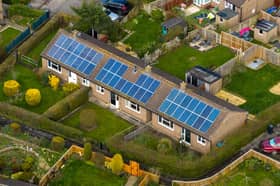 Close aerial view of houses in the village of Bishop Monkton with solar panels  on traditional bungalows showing renewable energy use in a rural North Yorkshire village.