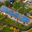 Close aerial view of houses in the village of Bishop Monkton with solar panels  on traditional bungalows showing renewable energy use in a rural North Yorkshire village.