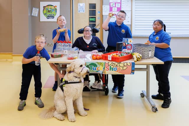 Tesco’s Free Fruit & Veg for Schools programme also help pupils learn life skills, like selling items from a tuck shop - approved by Poga, the school's therapy dog.
