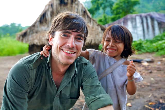Simon Reeve with the son of Mamo Luntana of the Kogi tribe. Photographer: Craig Hastings/BBC