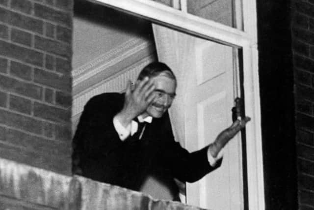 Neville Chamberlain waving from at window of 10 Downing Street