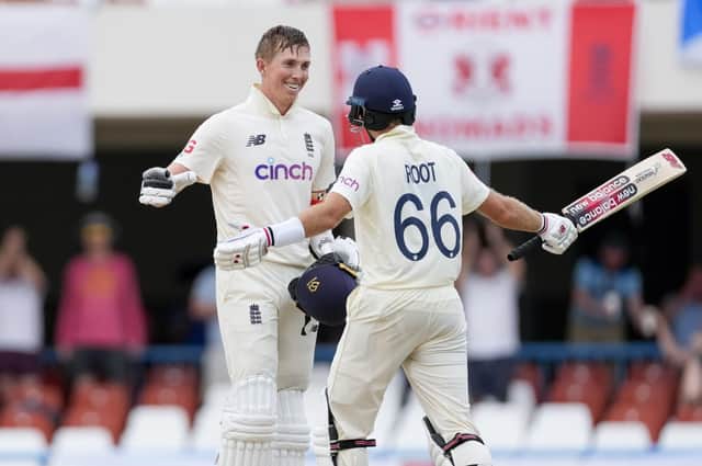 England's Zak Crawley celebrates with captain Joe Root after scoring a century against West Indies. (AP Photo/Ricardo Mazalan)