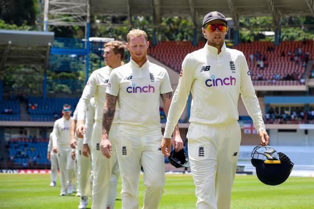<p>Joe Root and Ben Stokes lead England off the field after defeat to West Indies in Grenada. Picture:  RANDY BROOKS/AFP via Getty Images)</p>