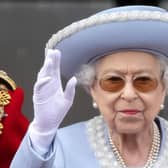 Queen Elizabeth II waves to the crowds on the balcony of Buckingham Palace.