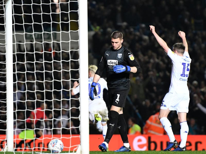 West Brom goalkeeper Sam Johnstone stands dejected as Ezgjan Alioski runs off to celebrate.