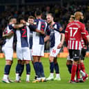 West Bromwich Albion's Darnell Furlong (second left) celebrates with his team-mates after his long throw-in leads to Sheffield United's Jack Robinson scoring an own goal. Pictures: PA.