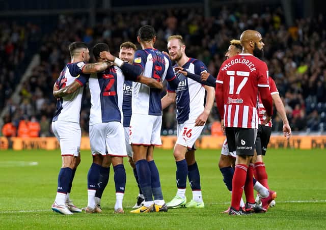 <p>West Bromwich Albion's Darnell Furlong (second left) celebrates with his team-mates after his long throw-in leads to Sheffield United's Jack Robinson scoring an own goal. Pictures: PA.</p>