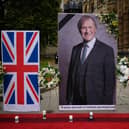 Floral tributes along with a large photograph of MP Sir David Amess. The man accused of murdering him has appeared at the Old Bailey. (Photo by Leon Neal/Getty Images)