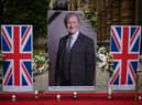 Floral tributes along with a large photograph of MP Sir David Amess. The man accused of murdering him has appeared at the Old Bailey. (Photo by Leon Neal/Getty Images)