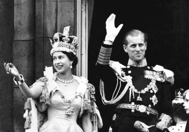 File photo dated 2/6/1953 of Queen Elizabeth II, wearing the Imperial State Crown, and the Duke of Edinburgh, dressed in uniform of Admiral of the Fleet, wave from the balcony to the onlooking crowds at the gates of Buckingham Palace after the Coronation. The start of the Queen's Jubilee celebrations falls on a significant anniversary for the monarch - her Coronation Day. Sixty nine years ago, Elizabeth II was crowned in religious ceremony staged on June 2 1953 in the historic surrounds of Westminster Abbey and celebrated with street parties across the country. Issue date: Thursday June 2, 2022.