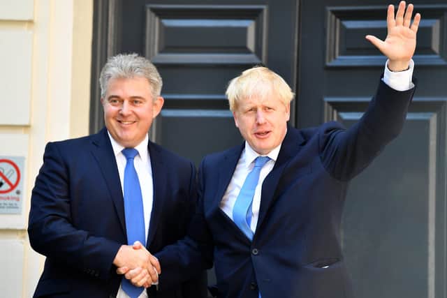 The Northern Ireland Secretary Brandon Lewis yesterday urged Boris Johnson to go, having backed him from Belfast earlier in the day. Above, Mr Lewis in happier times when he was chairman of the Conservative Party with Mr Johnson after the latter became Tory leader and prime minister, in July 2019