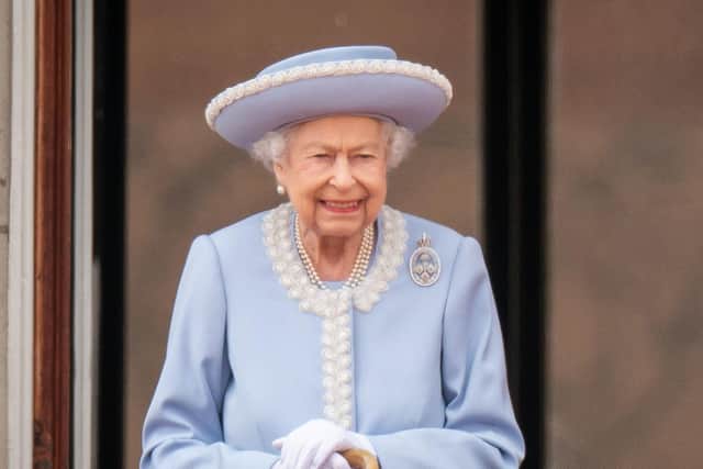 Queen Elizabeth II watching the Royal Procession from the balcony at Buckingham Palace following the Trooping the Colour ceremony in June.