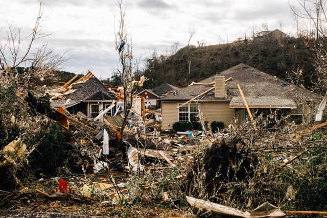 Fallen trees damage a property in the wake of a tornado in Fultondale, Alabama.