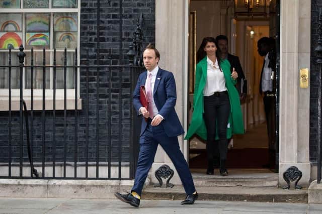 Matt Hancock leaves Downing Street in May, with Gina Coladangelo in the green coat (Photo: Getty Images)
