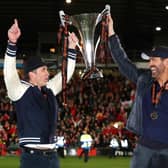 Wrexham owners Ryan Reynolds and Rob McElhenney celebrate the National League title in 2023. (Photo by Jan Kruger/Getty Images).