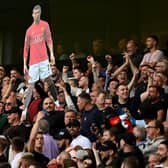 Fans of Manchester United hold up a cardboard cutout of Cristiano Ronaldo during the Premier League match between Wolverhampton Wanderers  and  Manchester United at Molineux on August 29, 2021 in Wolverhampton, England. (Photo by Shaun Botterill/Getty Images)