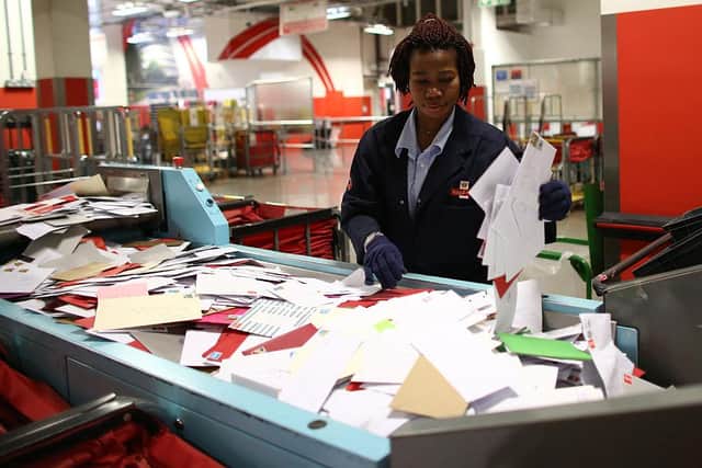 An employee sorts deliveries at Royal Mail's Mount Pleasant Mail Centre. (Photo: Carl Court/Getty Images)