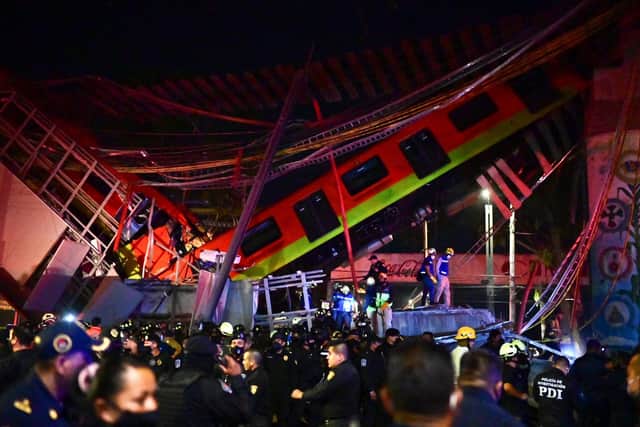 Rescue workers gather at the site of a metro train accident after an overpass partially collapsed in Mexico City (Photo by Pedro PARDO / AFP) (Photo by PEDRO PARDO/AFP via Getty Images)