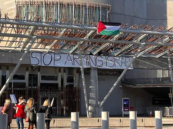 Four protesters have climbed onto the Scottish Parliament roof. Picture: Lisa Ferguson