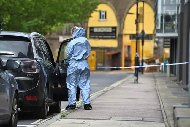 A police forensic investigator stands at a cordon in Peckham, southeast London, close to where black equal rights activist and mother-of-three Sasha Johnson was shot in the head during the early hours of Sunday (PA).