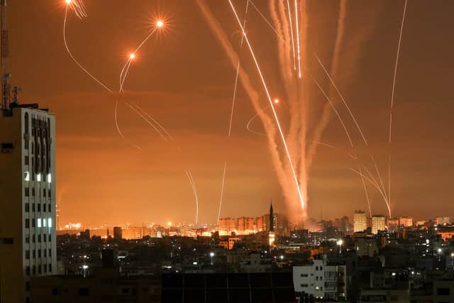 Rockets light up the night sky as they are fired towards Israel from Beit Lahia in the northern Gaza Strip (Photo by MOHAMMED ABED/AFP via Getty Images)