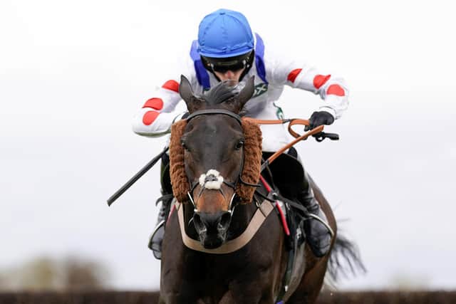 Clan Des Obeaux, ridden by Harry Cobden, clears the last on their way to winning the Betway Bowl Chase.