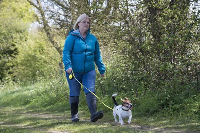 An actress (pictured) plays the role of PCSO Julia James walking her Jack Russell dog Toby - as they reconstruct the route taken by Julia and Toby in the fields behind her home in the hamlet of Snowdown, near Aylesham, Ken (PA).